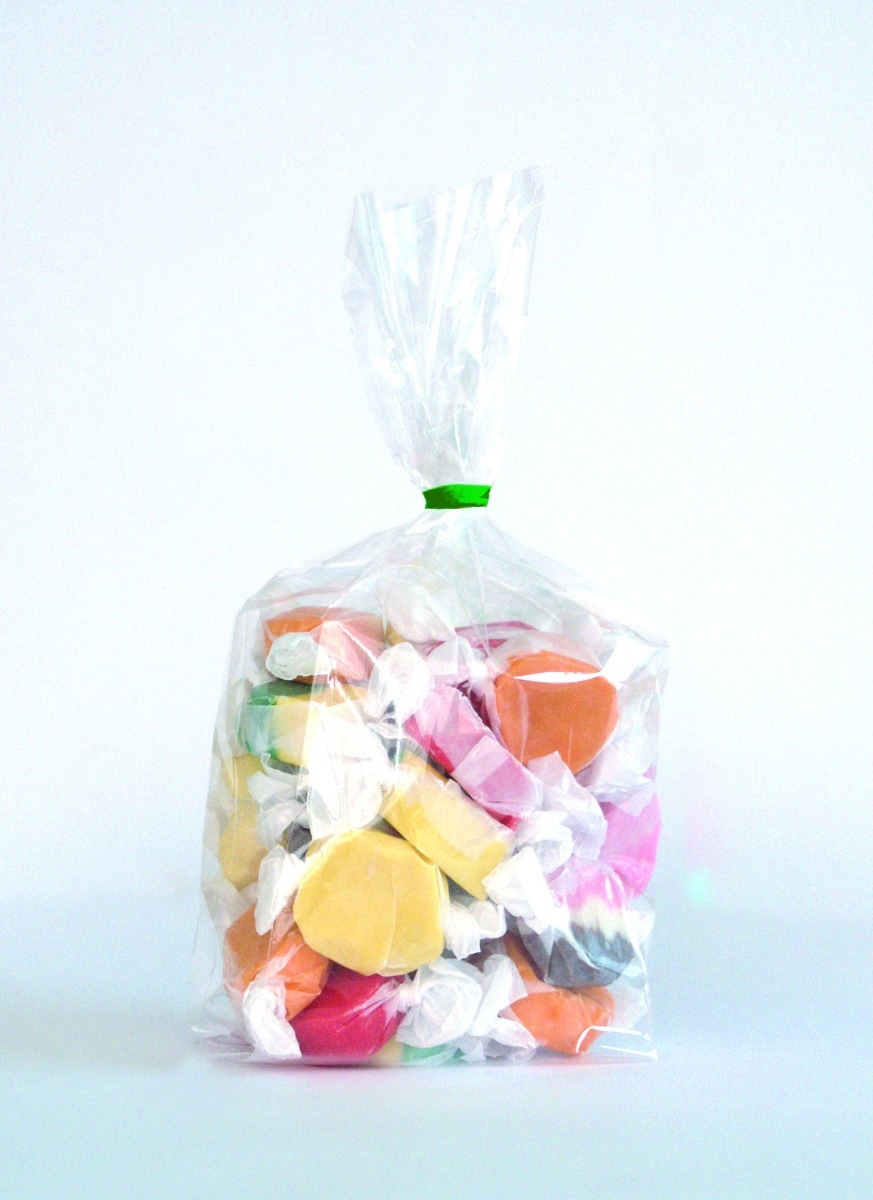 assorted candies inside polypropylene bag on white background